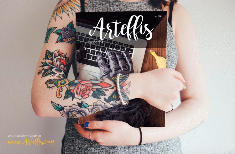 Free Magazine Mockup held by a tattooed woman