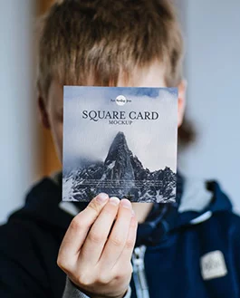 Free Little Boy Showing Square Card Mockup PSD