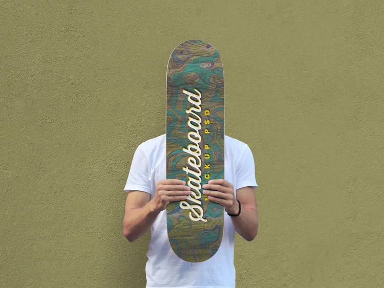 Free Man Holding Skateboard Mockup PSD