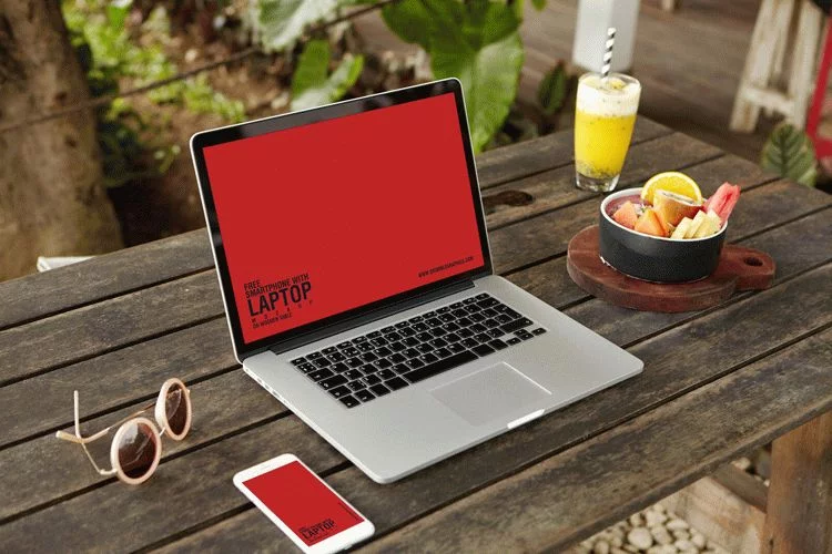 Free Smartphone With Laptop PSD Mockup on Wooden Table