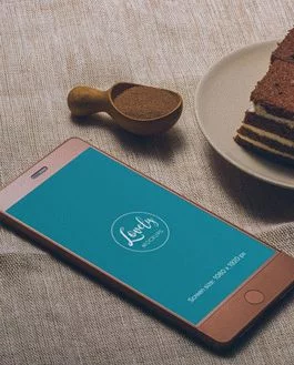 Smartphone and a tasty Cake on a Table