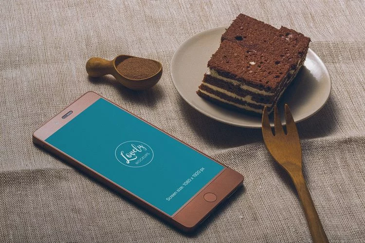 Smartphone and a tasty Cake on a Table